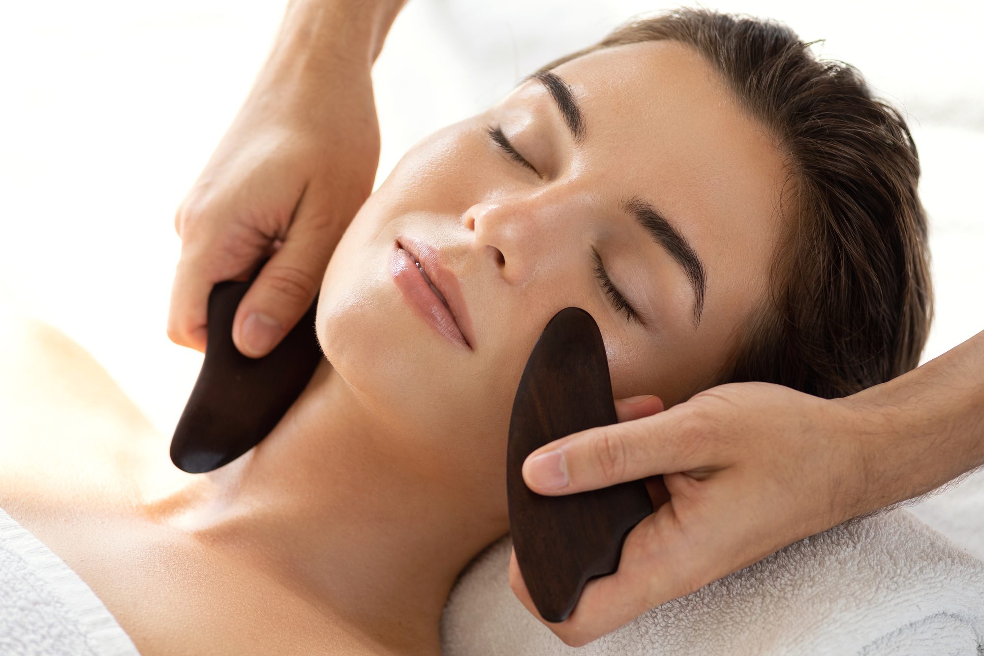 Woman during Chinese traditional massage - Gua Sha